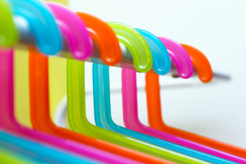 multicolored hangers on white background