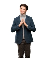 Teenager man with turtleneck scheming something over isolated white background