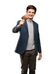 Naklejka premium Teenager man with turtleneck holding a wallet over isolated white background