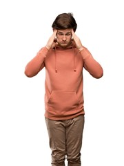 Fototapeta premium Teenager man with sweatshirt with headache over isolated white background