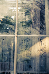 handprints and writing on a dirty window