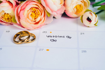 Word Wedding to Reminder Wedding day with Wedding ring on calendar planning and office tool.