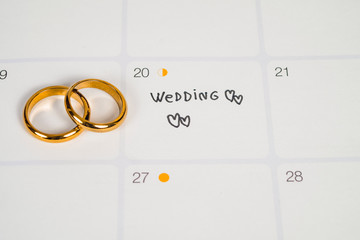 Word Wedding to Reminder Wedding day with Wedding ring on calendar planning and office tool.