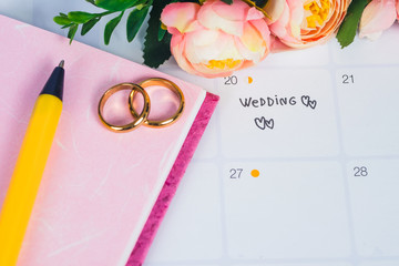Word Wedding to Reminder Wedding day with Wedding ring on calendar planning and office tool.
