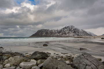 Rocks falling into the sea near Skagsanden beach. Lofoten islands, Norway