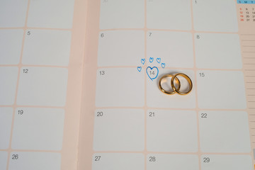 Word Wedding to Reminder Wedding day with Wedding ring on calendar planning and office tool.