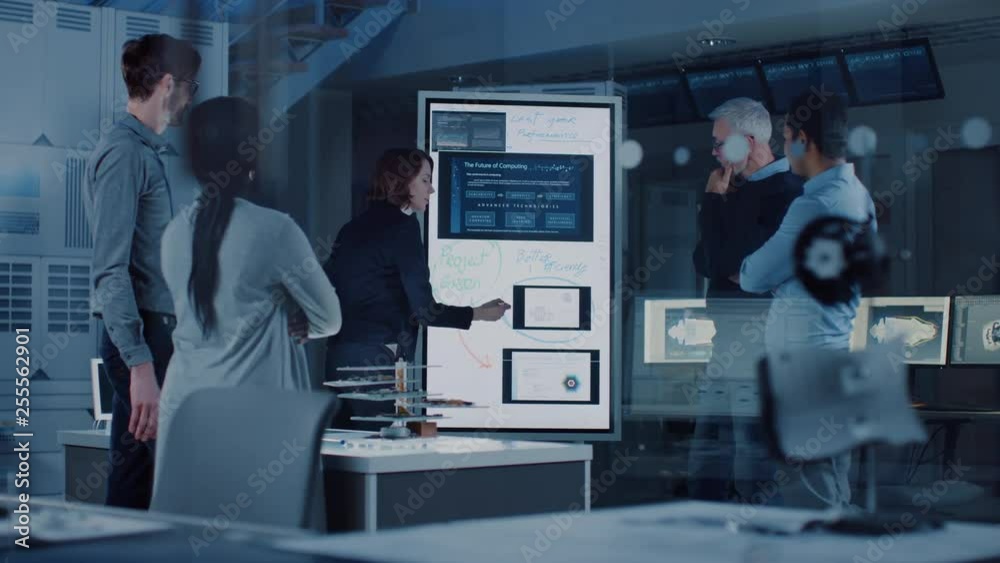 Poster engineers meeting in technology research laboratory: female engineer leads presentation writes on in