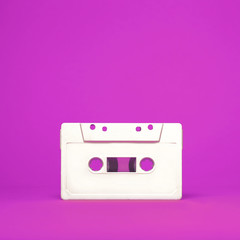 Fototapeta premium Audio cassette. Vintage white audio cassette tap on colored background. Old cassette tape audio isolated on white.