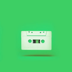 Audio cassette. Vintage white audio cassette tap on colored background. Old cassette tape audio isolated on white.