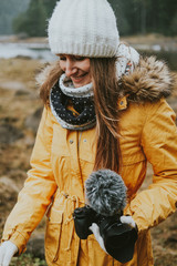 young woman in winter park with camera