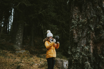 girl in the forest with camera