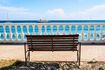 Bench and balustrade on a background of blue sea