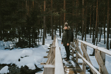 man walking on bridge in winter