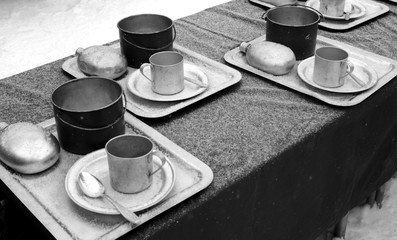 Table with metal army utensils.