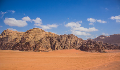 Fototapeta na wymiar Wadi Rum rocks bare mountain ridge Jordanian desert panorama scenery landscape travel and touristic photography 