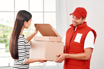 Good customer service costs less than bad customer service. Young woman receiving parcels from delivery man