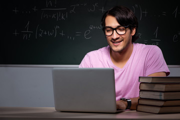 Young male student sitting in classroom