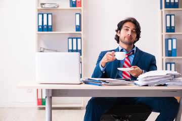 Young handsome businessman sitting in the office 