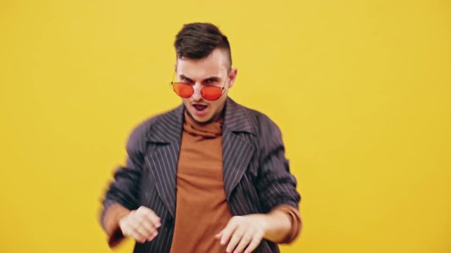 Cool dancing hipster guy in sunglasses