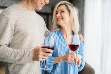 Adult love couple drinks red wine at home