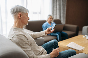 Cheerful adult love couple resting at home