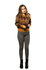 A full-length shot of a Teenager girl with brown sweater holding a wallet over isolated white background