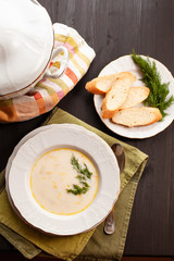 Creamy fish soup with salmon, potatoes, onions and carrots