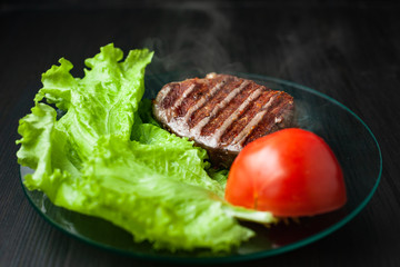 Hot roasted meat on a plate with vegetables