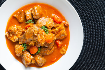 Food concept french classic veal stew marengo de veau in white ceramic plate with copy space