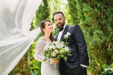 the bride and groom on the background of a mountain stream