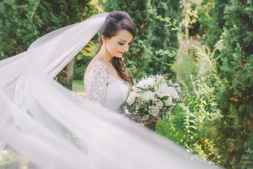bride in green and flying bridal veil