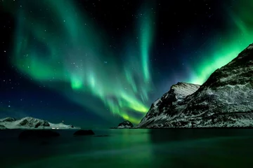 Poster Beautiful green Northern Lights at Haukland Beach on the Lofoten Islands in Norway © Nils