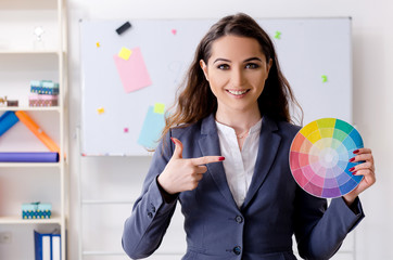 Young female designer working in the office 