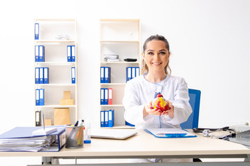 Young female doctor cardiologist sitting at the hospital 