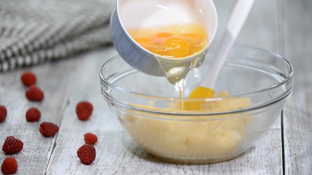 Adding chicken eggs to the dough.