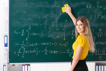 Young female student in front of the chalkboard