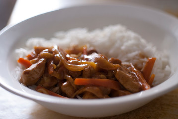 Tasty Beef Stroganoff and rice on white plate
