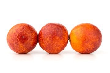 Bloody orange on a white background. Three red orange close-up on a white background.