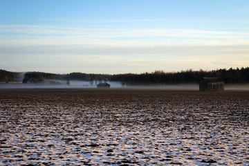 Scenic sunset and mist on fields, Finland