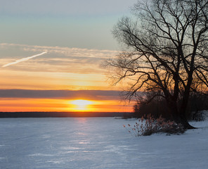 Beautiful sunset on the greate Volga river. Lot of ice on the  winter river