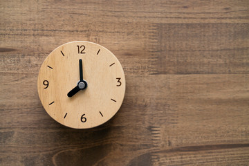 Retro alarm clock on wooden table, vintage style top view