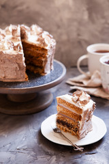 Homemade Kiev cake, dacquoise cake with butter cream and hazelnuts. Gradient  layers in brown shades