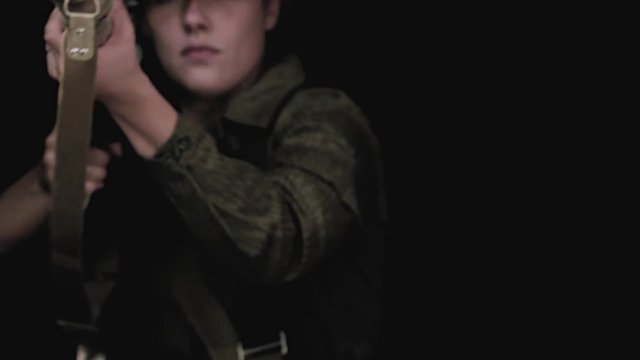 A female sniper is aiming with a dragunov rifle out of a broken window