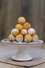 Donuts on a tray sprinkled with powdered sugar