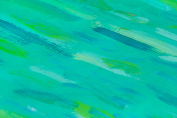Abstract view of a turquoise wooden board with green paint stains as background, texture