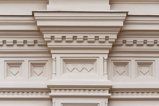 Fragment of the relief frieze with geometric pattern  on the wall of beige stone ancient building