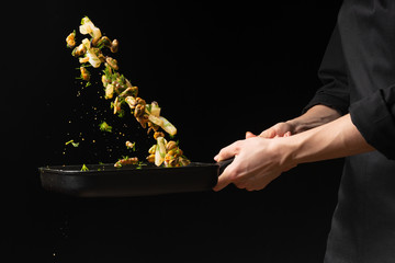 Professional chef prepares seafood with greens. octopus kalmar mussels. Sea food. Asian and Eastern cuisine. culinary background. Food freeze. Close-up menu © Anton