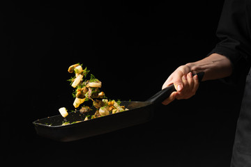 Professional chef prepares seafood with greens. octopus kalmar mussels. Sea food. Asian and Eastern cuisine. culinary background. Food freeze. Close-up menu © Anton