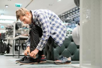 the process of tying shoelaces on brand new boots