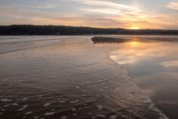 Landscape image of Oxwich Bay at sunset in the Gower Peninsula, South Wales. 